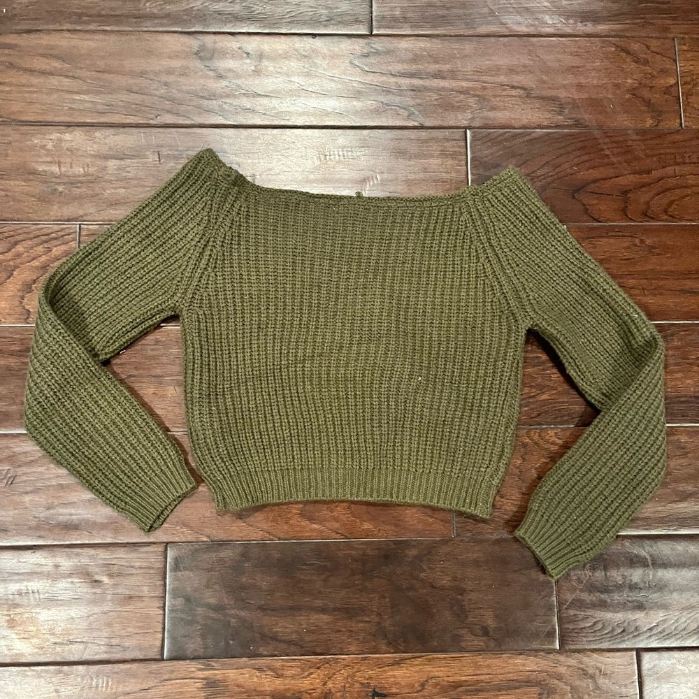 Long-sleeve olive green knitted sweater.